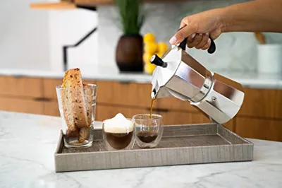 Stovetop Espresso Maker, 6-Cup Moka Pot, Silver, in use.