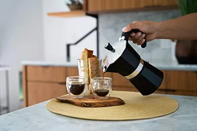 Stovetop Espresso Maker, 3-Cup Moka Pot, Black, in use.