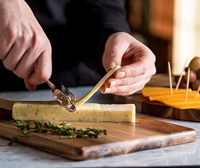 Stainless Steel Wire Cheese Slicer with 2 Extra Wires, Gold, in use.