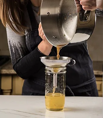 Stainless Steel Funnel for Kitchen, 5 Inch with Strainer, in use.